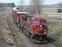 An eastbound Canadian Pacific train, led by a pair of AC4400CW’s in their as built duel flags paint scheme, is seen at the Highway #2 crossing, west of Woodstock, Ontario on the Galt Subdivision.  