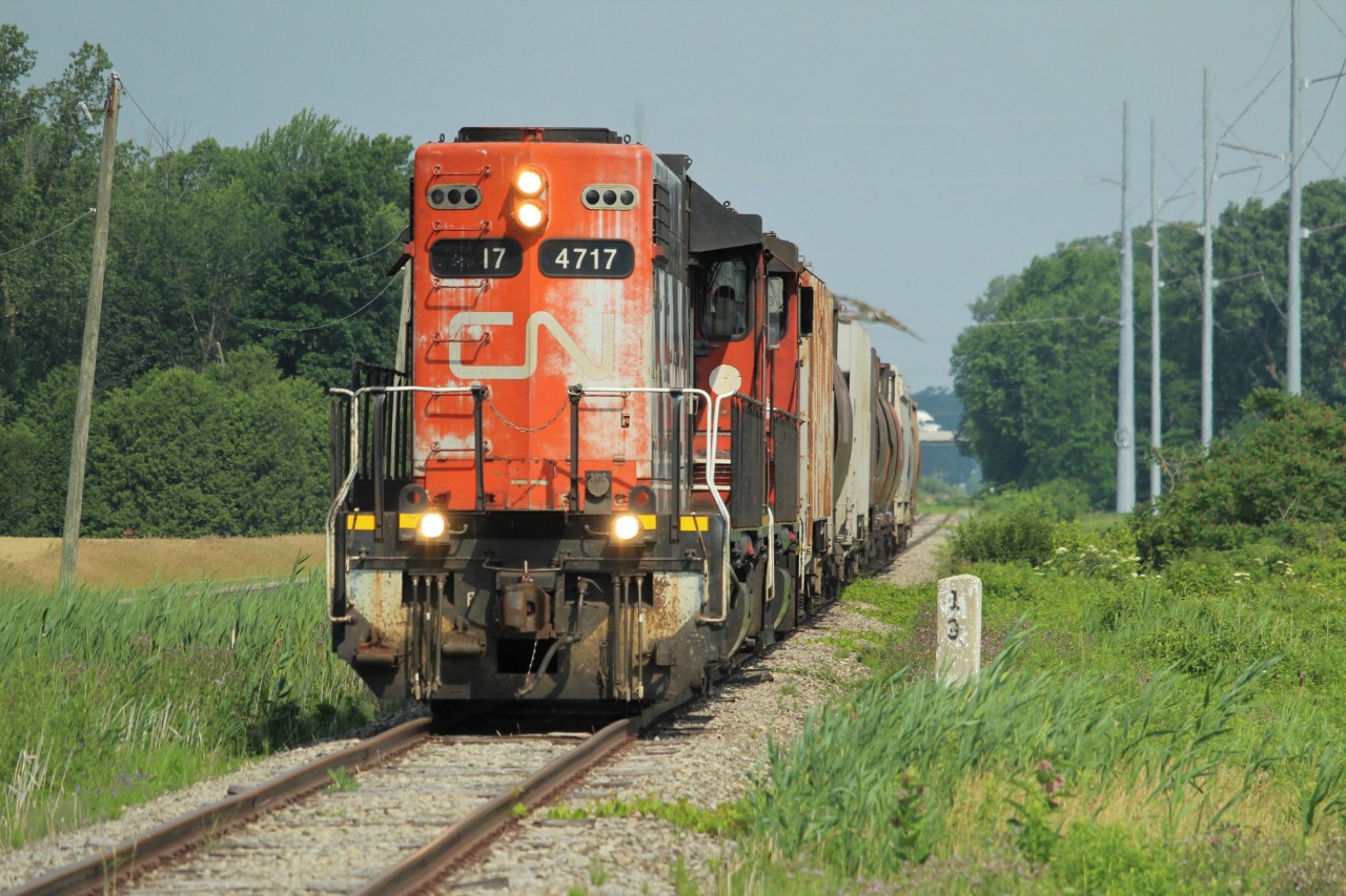CN 4717 and 4777 have just tucked under the 401, making the slow and steady trek down the Sarnia Spur with a string of empty hoppers for the elevators in Blenheim. This is perhaps my favourite run in the province, combining a local job, a relic of a branchline, grain hoppers/elevators, and open countryside.