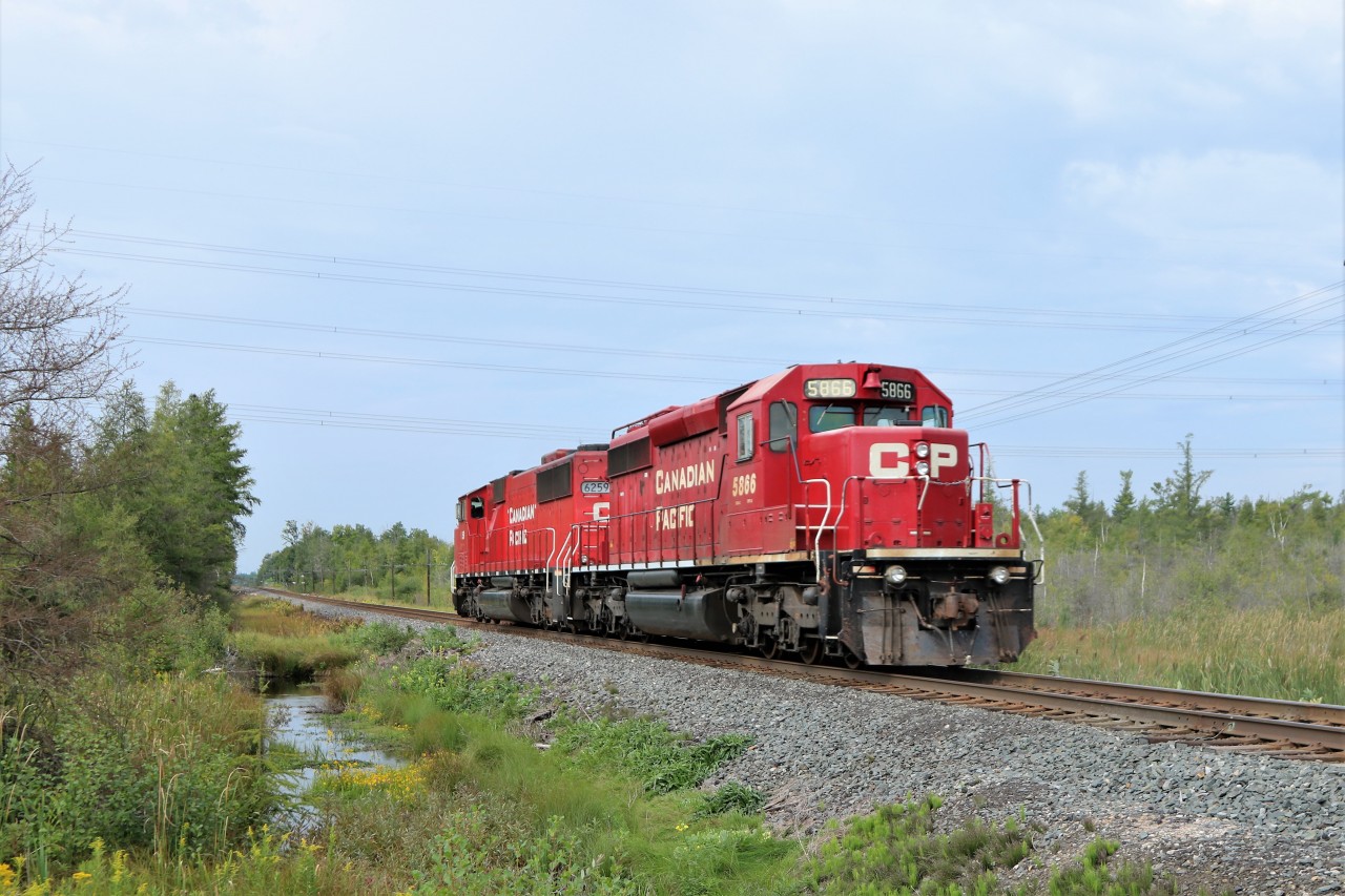 Having been parked at Guelph Junction all weekend as the power for the ribbon rail train, CP 6259 hauls a broken down CP 5866 westward light power, towards London where repairs will be done.
