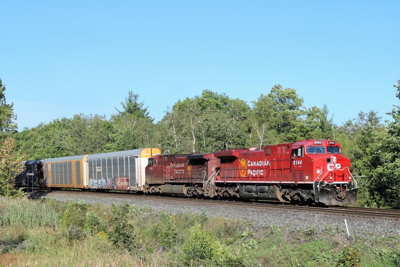 Former CP 9626, all cleaned up and reconditioned and renumbered to CP 8144 leads CP 9705 past the Flanders sign and up to the Campbellville Road crossing on its way westward up the Galt sub cleared to Ayr.