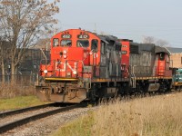 In fading evening light, CN GP9RM 4112 and GP38-2 4700 have entered the Talbot Subdivision in London, with cars destined for industries in St. Thomas. 