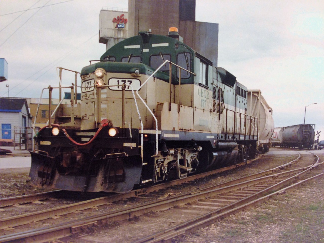 Goderich-Exeter Railway (GEXR) GP9 177, departs the large Sifto Salt mine in Goderich, Ontario with three hoppers and heads up the steep grade towards the yard on April 28, 1995. The former Cartier Railway unit would operate on GEXR until 2002, after a damaged main generator sidelined it for good.