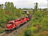 After being tied down in Guelph Junction over night, The "work train" as its been called heads south out from under highway 6 approaching the Newman Road overpass with quite the pair for power in SD40-2 5866, and SD60M 6259 for power.