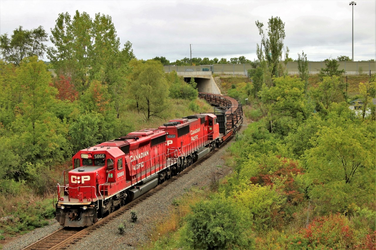 After being tied down in Guelph Junction over night, The "work train" as its been called heads south out from under highway 6 approaching the Newman Road overpass with quite the pair for power in SD40_2, 5866 and SD60M 6259 for power.