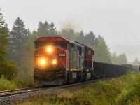 <b>HAPPY RETIREMENT!</b><br><br> On a rainy Wednesday, westbound train 406 heads through Passekeag, New Brunswick, with a small train in tow. Engineer Warman, aka, "Pappy" is making his last trip, retiring after 40+ years of working on the railroad. Best of luck, and enjoy retirement! 
