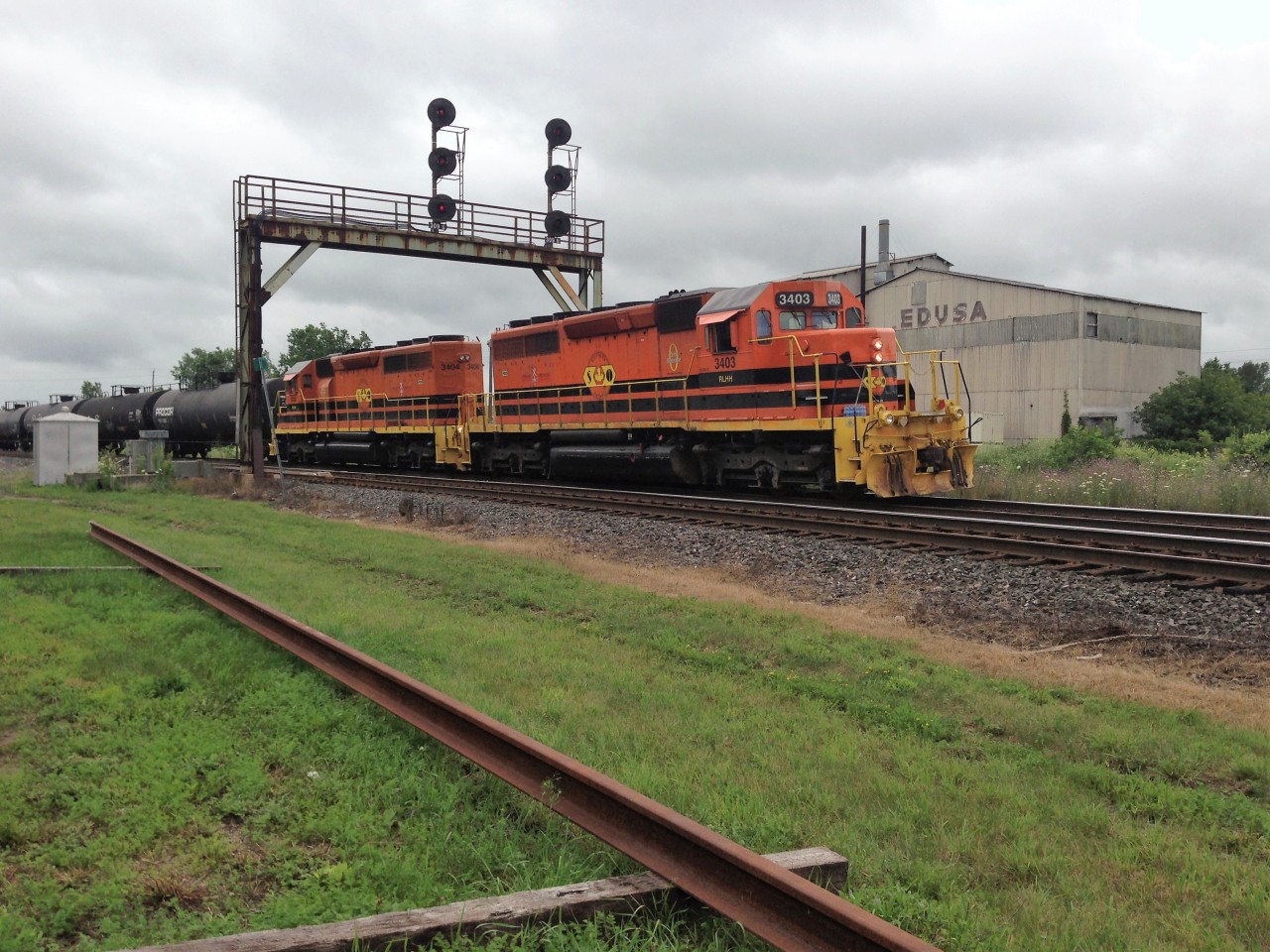 Southern Ontario Railway (SOR) train 597 is seen making a rare daylight appearance in Paris, Ontario as it lifts cuts of tank cars left by CN on July 24, 2017. The train is powered by RLHH SD40-2’s 3403 and 3404.