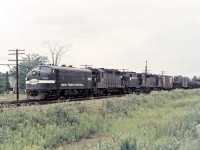 Here is an interesting early merger consist heading west through Canfield in September 1968: NYC F7A 1832, PRR GP35 2346, a former PRR RS27 now in PC paint, and another PRR GP35.