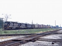 Although the Penn Central merger finally took effect on 1 February 1968, you could still see solid lash-ups of NYC power on the Canada Division for the first year or two. In this shot from Penn Centrals first summer, we see GP40 3047, GP 7379, and an unidentified F7B lead a train westward. 