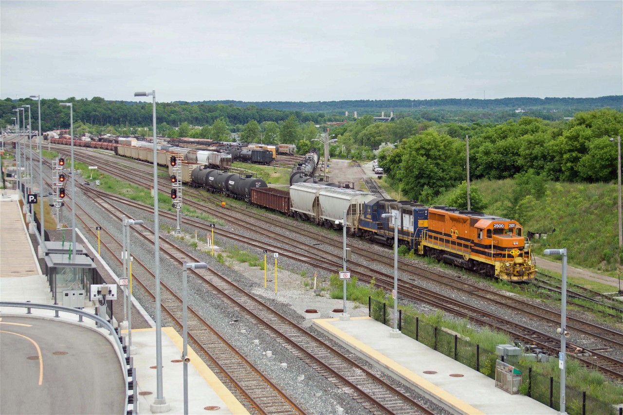 In many ways, this photo is symbolic of the evolution of the Canadian rail industry. The location, of course, is the Stuart Street yard in Hamilton, once the hub of the historic Great Western Railway and later an important centre on the Grand Trunk. It became a regional hub for Canadian National until downsizing reduced its importance in the 1990s. This was followed by out-sourcing to the short line Southern Ontario Railway in 1997 (represented by former Railink GP 4003 in this photo). These smaller railroads were consolidated under Rail America and later Genesee & Wyoming (represented by Quebec-Gatineau GP35u 2500 in G&W paint). And now a form of re-birth, as the "West Harbour" area of Hamilton is transformed from a former industrial area to an urban residential area complete with GO Station. And the "circle of life" will complete later this year as this facility becomes a CN operation once again.
