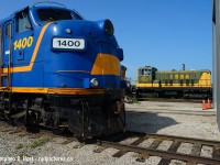 Of course, Only on the Ontario Southland Railway.. but I'd  never have guessed this.... would happen in 2018.   Truth is, the owner of 1556 is Don Broadbear whom is a director of the Ontario Southland Railway hence a major shareholder so it's being stored by OSR after finishing its tenure on the Waterloo Central. 1556 - a former Port Stanley Terminal Railway (and St. Thomas Central / Waterloo Central) engine is now inside the shop parked behind CP 24 the business car.  The PSTR and OSR have very similar roots, where many of the leaders and employees of both railways started with the Pinafore Park Railway in St. Thomas, a long defunct narrow gauge steam road inside a public park (Equipment is now at Muskoka Heritage Place - many photos on this site posted by Wayne Shaw - Search for 'em!). OSR and the PSTR are both very successful organisations, but who knows what may be possible once the PSTR gets connected to the mainline in St. Thomas. Will it ever happen? 
