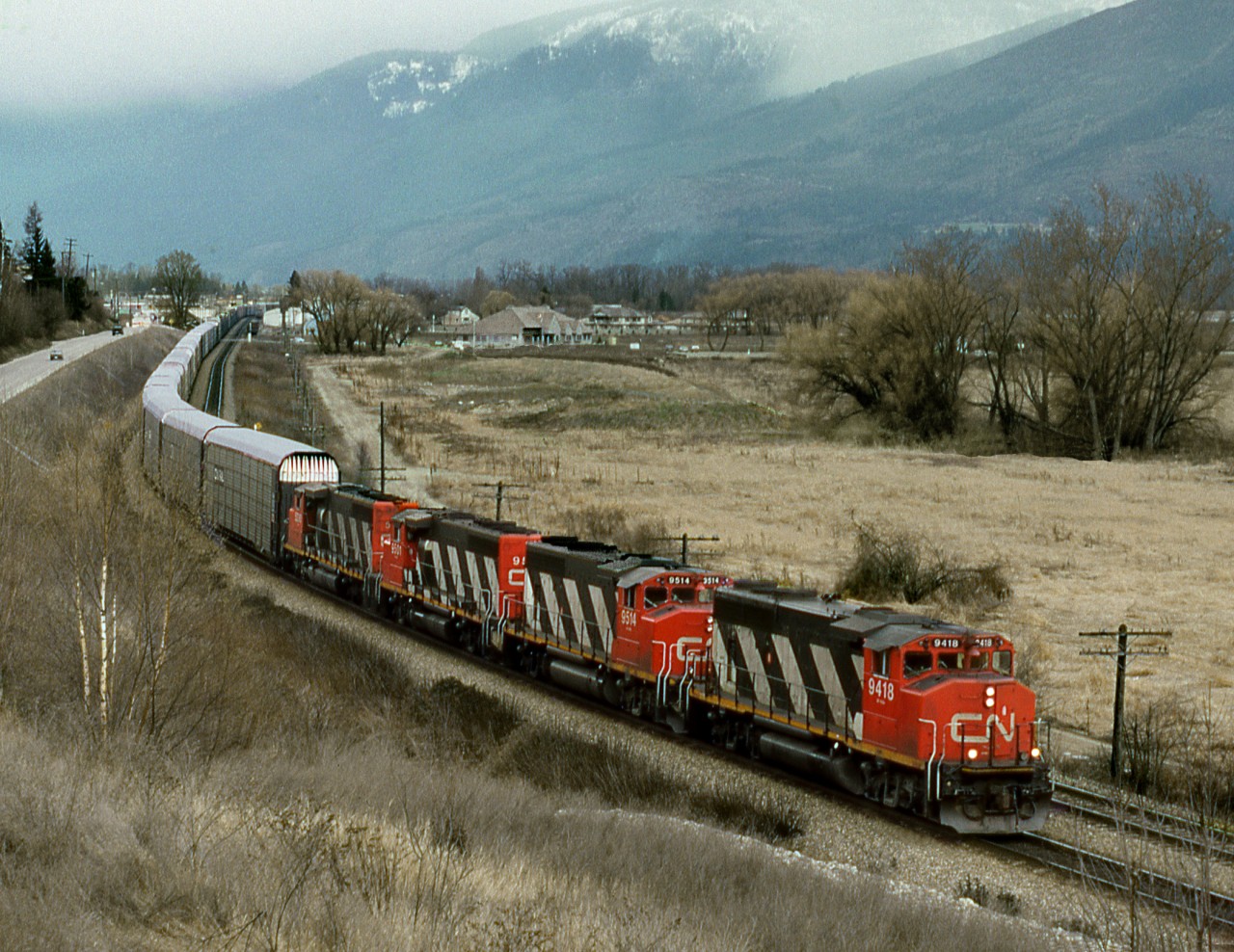 A mishap on CN east of Kamloops resulted in detour over CP. An eastbound auto racks departs Salmon Arm on Shuswap Lake.