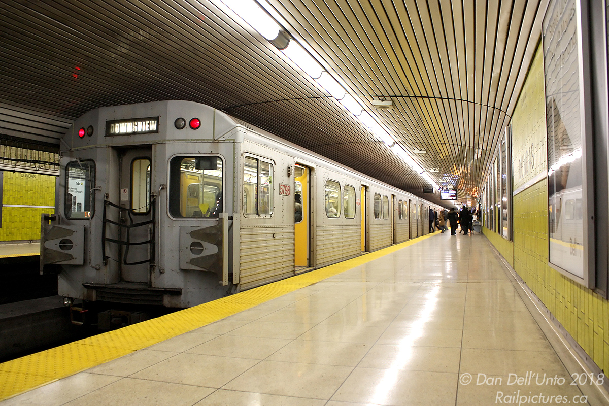 Still two years away from extinction by new replacement Toronto Rocket trains that would take over, the mid-70's Hawker Siddeley Canada H5 cars were just more of the same that provided daily service on the Yonge-University-Spadina line (aka "Line 1") combined with newer T1 cars. But when you know the writing is on the wall, it's best to nab 'em when they're still plentiful. Higher-numbered car 5798 brings up the rear of a 6-pack of H5's, paused at Dundas Subway Station to pick up more passengers (and let off the photographer after his trip down from Yorkdale station) before continuing up the Yonge line.

One change to some of the stations after the TR's entered service was removal of all the ceiling slats directly over the tracks (apparently due to the TR's roof-mounted HVAC system blowing out all the years of grime and dirt accumulated up there) but not over the platforms, giving the stations a somewhat unfinished look.
