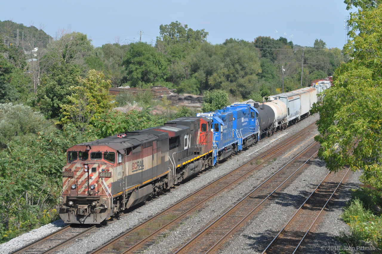 BCOL 4619 (Dash 8-40CMu Draper-taper cowl) and CN 2557 (Dash 9-44CW) power CN train 435, seen here during a head-end set off at the west end of Aldershot Yard. 
The blue GP38-2 units GMTX 2277 and 2325 are not running and will continue further west. Independent brake hoses are connected between all engines. The GMTX's are MU cabled together, but not to the lead locomotive pair.