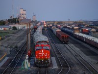 Twilight in Melville! Brand new CN ES44AC 3814 has just pulled onto the fuel pad awaiting a fill-up and a new crew to take the train to Saskatoon while plenty of other trains go about their duties.