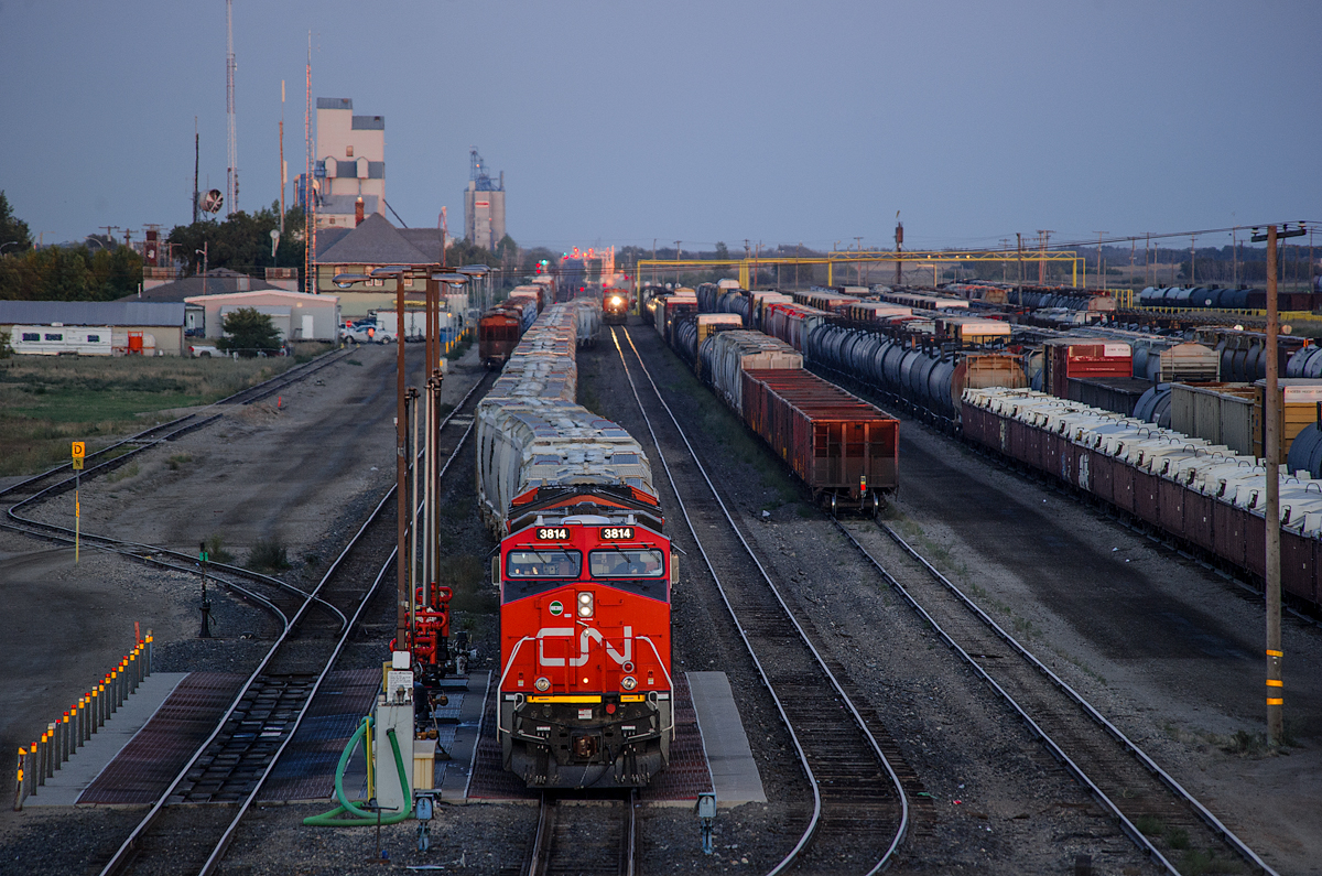 Twilight in Melville! Brand new CN ES44AC 3814 has just pulled onto the fuel pad awaiting a fill-up and a new crew to take the train to Saskatoon while plenty of other trains go about their duties.