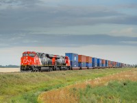 Brand new CN ES44ACs 3825 and 3826 make their maiden run west on train Q199 approaching Bloom on CN's Rivers Sub.