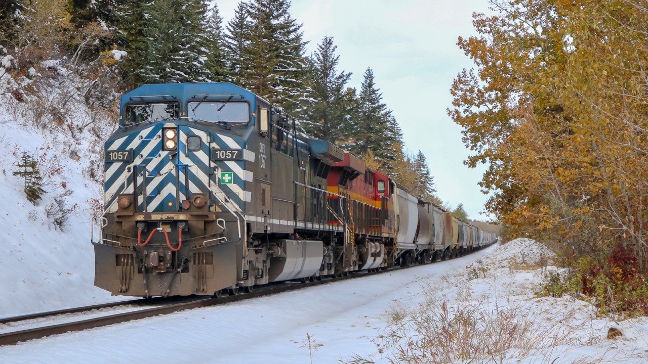 CEFX 1057, and KCS 4795 lead an empty CP grain train through a snowy fall scene in Calgary, AB.