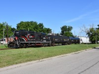 Having just crossed Park st seconds ago and now running parallel down Park st, CCGX 4015 makes its way south through downtown Brampton on a beautiful summer morning in late June. Trailing 4015 were a total of 8 freight cars and this was the OBRYs last run to Streetsville and back under CANDO as CANDO marked June 30th to be the day they leave Orangeville for good and a new operator ‘Trillium’ has since taken over operations on this 36 mile short line railway. <br> Time: 08:56