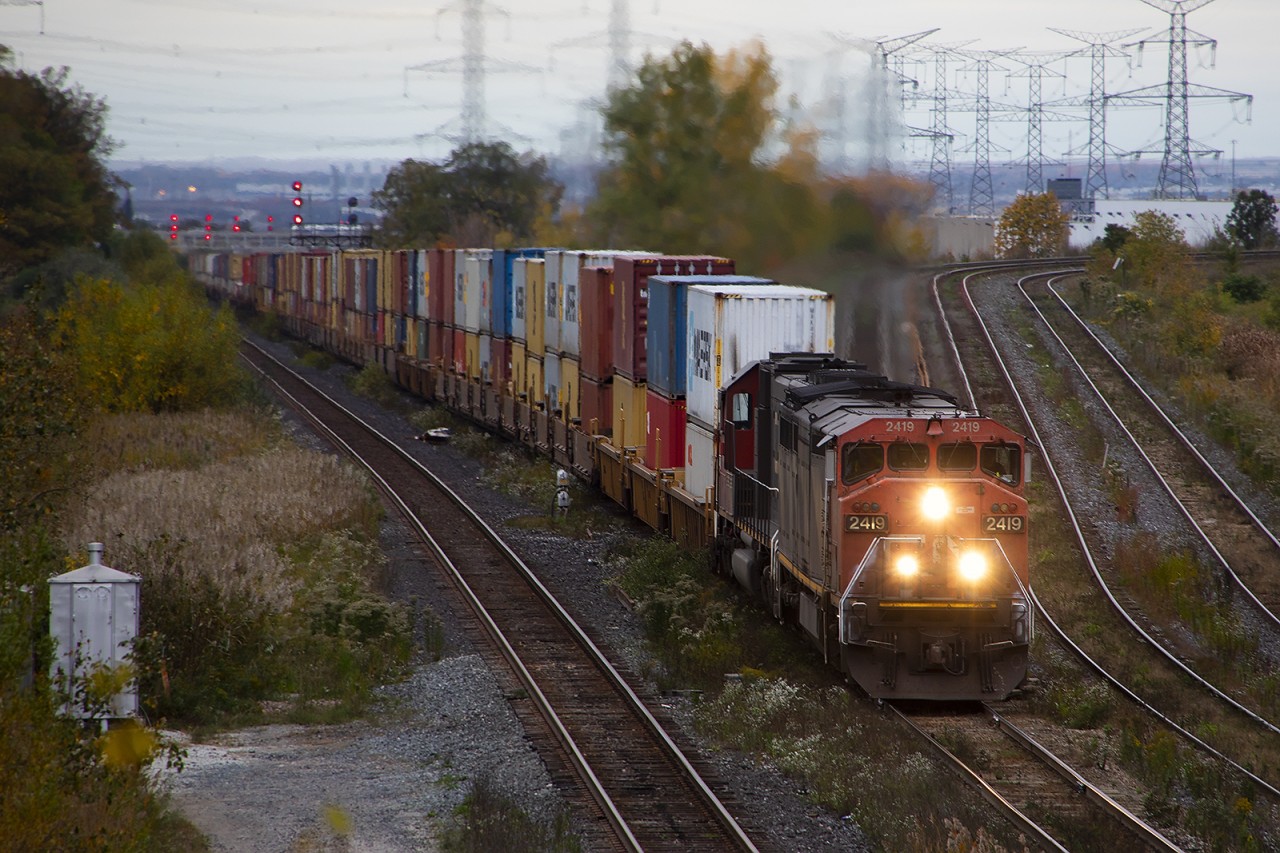 They're not quite on their knees, but 2419 and IC 1004 are down to about 20 mph as they crest the climb out of the Humber River Valley at dusk with 8000+ feet of containers on the drawbar.