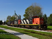 CN 1037 with CN 7046 shove a cut of hoppers into the elevator in Sarnia as Algoma Central's 1967 built bulker Tim S. Dool takes on a load.