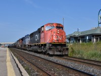 CN 5624 leads an eastbound freight through Bramalea GO on the beautiful sunny Sunday morning of 08/05/2018. Trailing the sd75I happened to be a foreign visitor, CITX 140 and one more striped CN unit behind the CITX. Time was 09:56