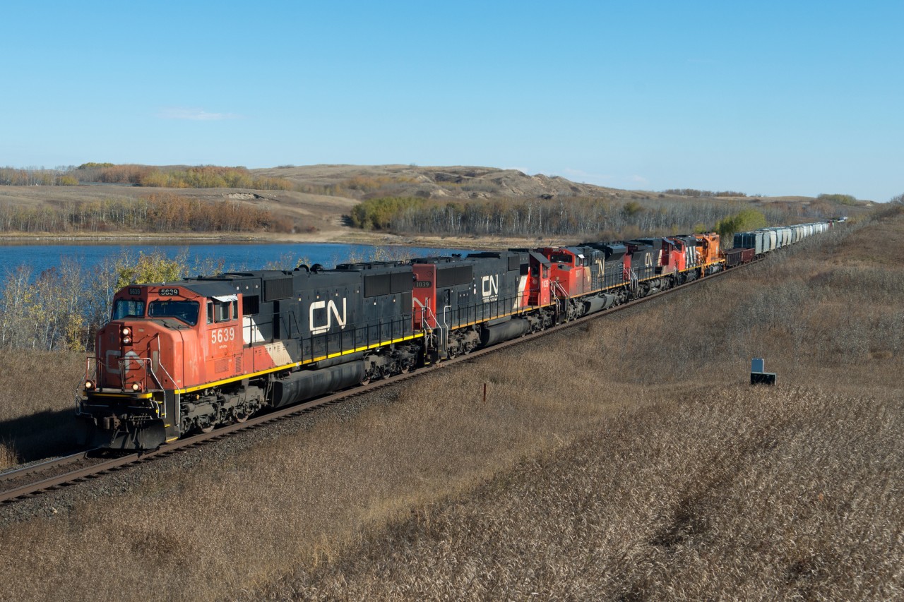 CN 5639 leads a large consist including EJE 672 on train 317 into Biggar on a perfect October day.