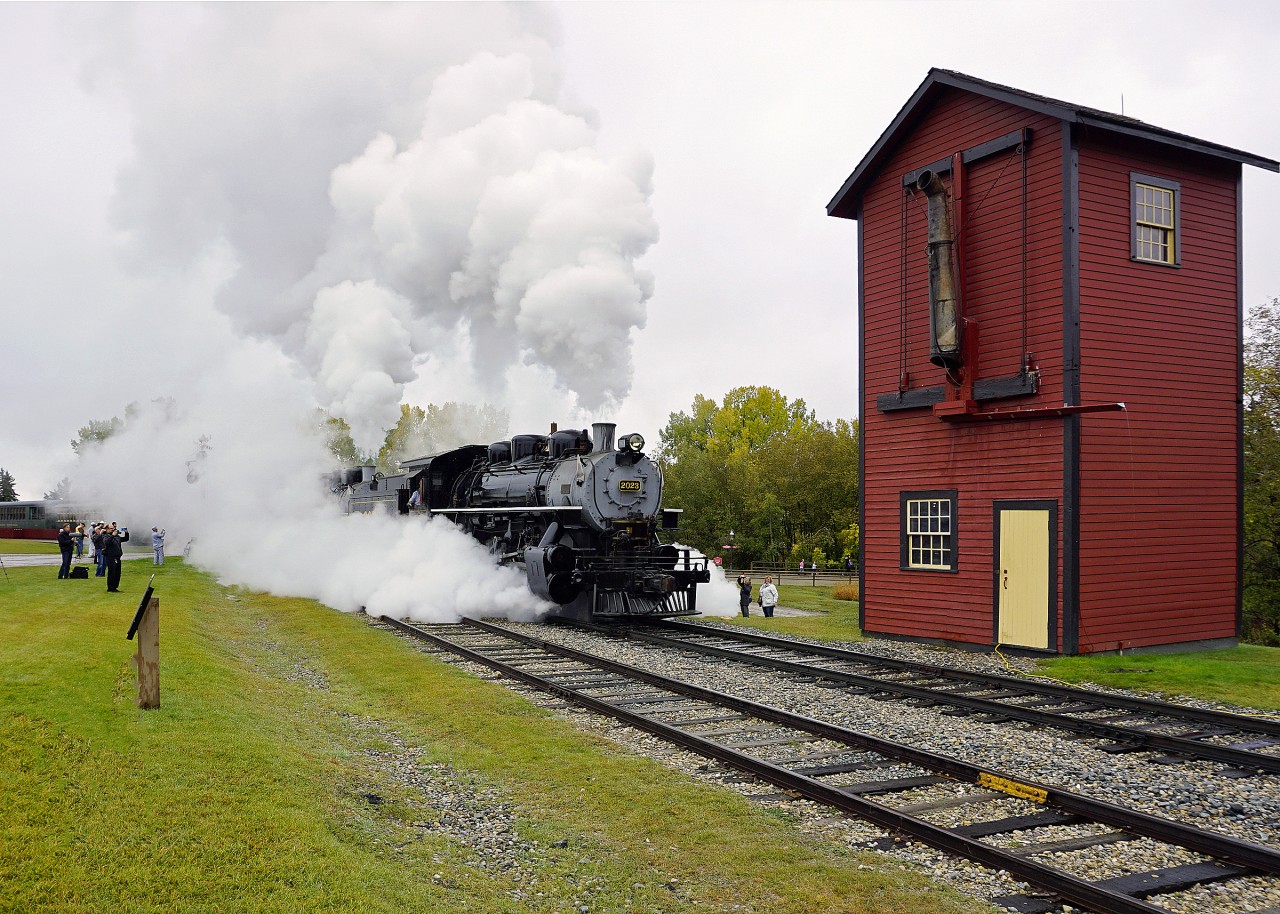 Heritage Park Railway Days were a bit slow this year due to the weather.  Cool damp conditions do however allow steam locomotives to put on quite a show.  Here Alco 0-6-0 CP 2023 and LIMA 0-6-0 CP 2024 depart Midnapore Station and are seen passing the water tower that will be used later in the day to demonstrate taking on water.