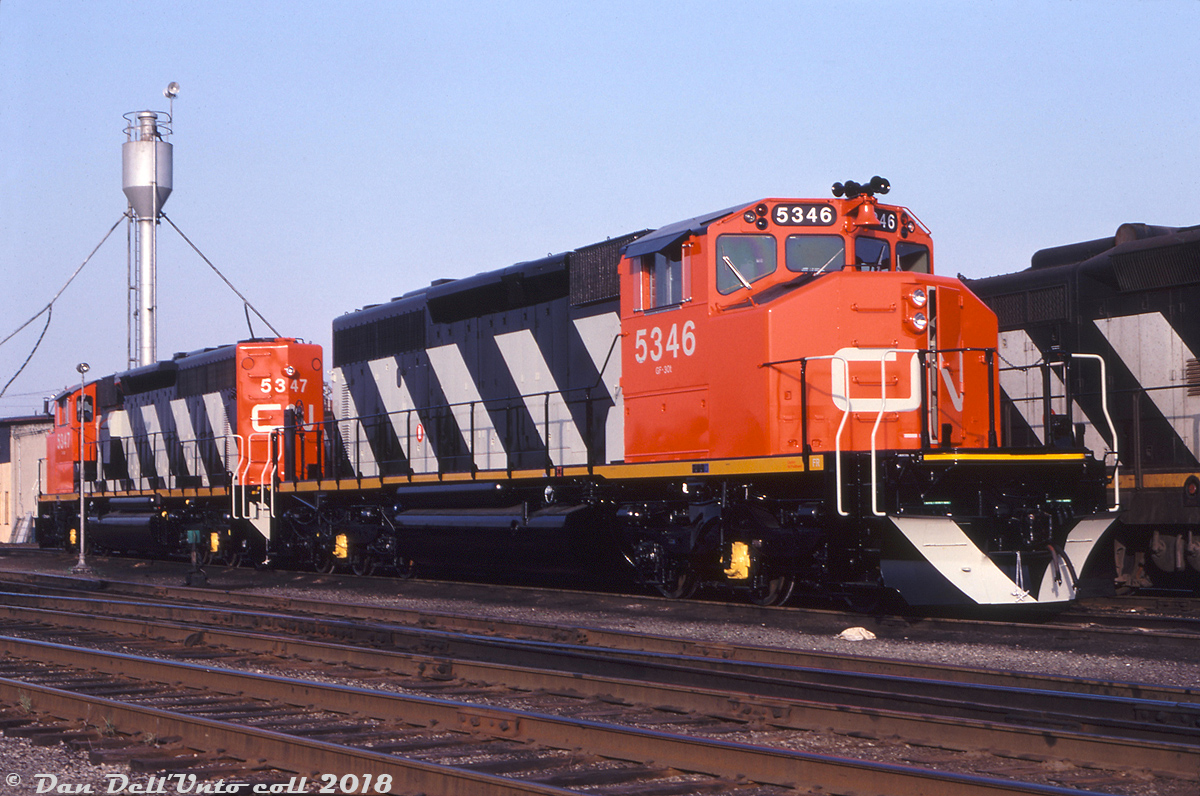 Fresh from the GMD London assembly plant, brand new CN SD40-2W units 5346 and 5347 sit in CN's yard in London awaiting their first assignment - with not a speck of dirt on their plow, fuel tank and trucks from regular service. The two were part of an order of 30 units (5324-5353, GF30t class) built in Apr/May of 1980, and all of CN's SD40-2's bought new came equipped with the CN-designed Canadian Safety Cab (the only railway to order SD40's so equipped).

Gord Taylor photo, Dan Dell'Unto collection.