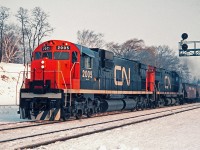 Six axle MLW C630-M 2005 built 1967 with MLW C-424 3233 are headed toward Hamilton with a load of ore destined for Dofasco. These standard hopper cars would be replaced later with cylindrical hopper cars which had two wheels on top which looked like they came off a wheelbarrow. The wheels were used to open the top doors for loading iron ore pellets which originated at the Sherman Mine in Temagami.