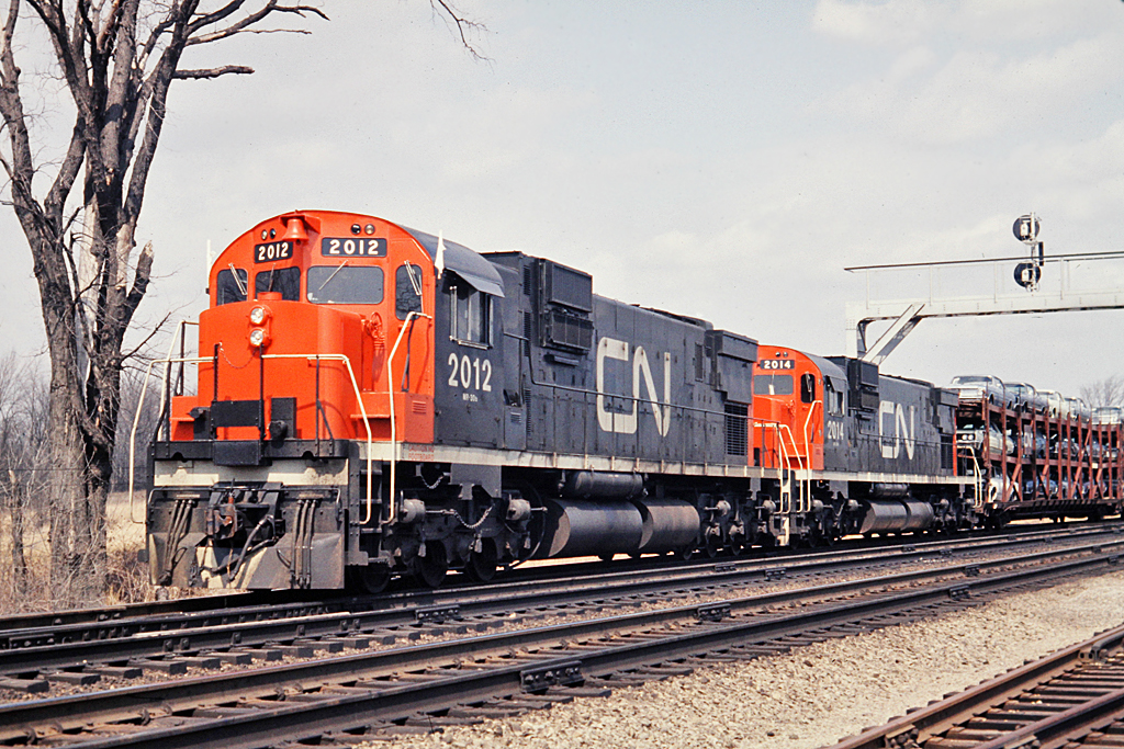 Elephant style MLW C-630M's 2012 and 2014 switch the west end of Aldershot Yard.  The tri-levels appear to be carrying 1968 Ford Falcons on the top deck and it looks like Ford Galaxies on the middle deck.