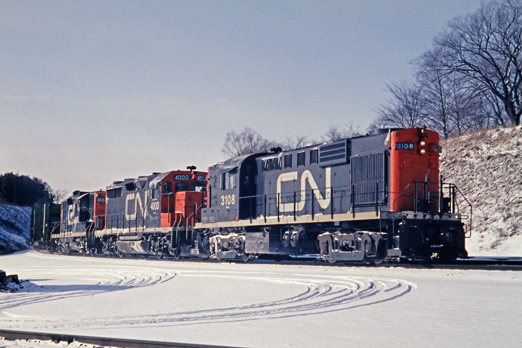 1-2-1  First generation, second generation, first generation diesels are lashed up here on train 396.  4000 is one of two GP-35's on CN that were built in 1964.  The 3108, an MLW RS-18 was built in 1959.