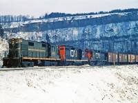 <b>No Graffiti!</b>  Back in the 60's, we did not have graffiti all over the sides of freight cars as witnessed here on train 307 at the site of the old Dundas station.  This westbound freight is grinding up the escarpment with the familiar rock outcropping which identifies pictures taken here.  The station is long gone but I am sure it will be remembered by many, including Mr. Mercer who I believe spent some time at the operator's desk.  