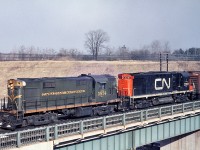 Flying white extre flags, CN 3874 with CN 3201 cross Hwy 403 at Hamilton West (now part of the Bayview interlocking) and start the climb to Copetown on the Dundas hill. RS-18 3874 was built in 1960 by MLW.  Fourteen years later, 3201 was built by MLW and retired in 1985.   