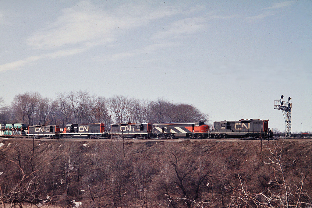 In the consist, CN 4518-6703-4485-5036-4596 at Bayview Jct. taken from the Spring Garden Road.  This location is mostly obscured by vegetation now making it difficult to replicate this shot.  Note that CLC CPA15-5 has been relegated to freight service.  The end of the C-Liners is drawing near.