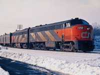 CLC built six of these CPA-16-5 passenger locos for CN along with six CPB-16-5 "B" units. They were 1600hp and geared for 83 mph.  Due to the low number on the roster, it was not too common to find one leading on a passenger train.  CN 6702 on train 146 has passed through the interlocking at Hamilton West (now called Bayview) and will head onto the Oakville Sub toward Toronto.  Note the wheel stops for the siding which no longer exists. 