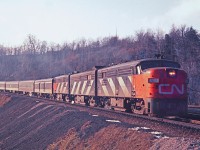 CN 6762 is down bound on the Dundas hill at the York Road bridge. There is just a trace of snow in this January scene with an all MLW A-B-A lashup. The winter sun is very low and is illuminating the trucks and fuel tanks.    