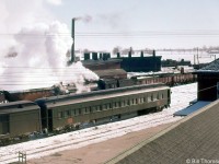 A winter scene at Palmerston back in 1958 showing the CN yard, roundhouse, turntable as viewed from by the station. Visible are passenger cars on the tracks near the station, a steamer in the yard working, hoppers and bottom-dump gondolas, and a CN 1700-series RSC13 in the background by the roundhouse, which were common branchline power in the area during the 1950's and 1960's.
