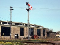 The rear of the C&O St. Thomas roundhouse near Elm St. & Wilson Ave. is pictured, with the crossing of the old L&PS line in the foreground and semaphore signals guarding it. This track lead to the C&O's car shops. One can see the locomotive servicing area off in the background.
<br><br>
Today C&O predecessor CSX doesn't call on St. Thomas anymore, the rails are all gone, and the roundhouse demolished. But, one can still see the outline of where the roundhouse once stood in aerial imagery.