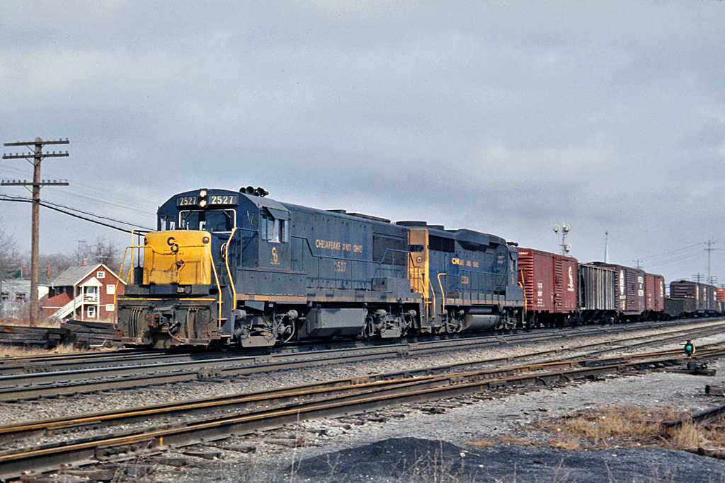 C&O 2527 is westbound at Hagersville, ON. on the CASO Sub.  The lead unit is a GE U25B and the trailing unit is a GP30.  The scar of where the tracks used to be is all that is left of this scene.