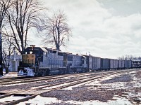 C&O on the CASO.  Classic 4-axle power passing through Waterford on a cloudy day with remnants of the winter snow. Open tri-levels would become a thing of the past.  