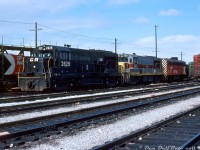 Whose railway is this anyway? Power for the CP/TH&B "Starlight" (Toronto-Hamilton) sits inside CP's Toronto Yard awaiting the call to duty. One could often find CP, TH&B, NYC/PC/CR or a mix of power on this train, but today's 70's mega-mix lashup features Conrail U25B 2625 in patched Penn Central black, U25B 2571 still sporting Erie Lackawanna paint from its former bankrupt owner who was squeezed into Conrail the previous year, and CP F7B 4438 tacked on for good measure (looking back, one could often note the "token B-unit" tacked onto many different CP lashups of that era, including behind modern 6-axle units. Extra power was extra power I suppose).<br><br>These same two CR U-boats were noted in a photo taken a few weeks earlier at Stoney Creek trailing a TH&B Geep, so I would hazard a guess they found their way north on the "Kinnear" from Buffalo and stayed around for a bit. Maybe one of the usual suspects can chime in on how long PC/CR power stuck around on the TH&B/CP for.<br><br><i>Bill McArthur photo, Dan Dell'Unto collection.</i>