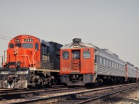 <B>Coming through.</B>  Three Budd RDC's at track speed pass CN 2001 who is taking some time switching at Aldershot.  The crew in the RDC are quite visible.  The RDC's were renumbered into the 6100 and 6200 series.  There are several surviving RDC's stored at the Toronto Maintenance Centre (TMC).  VIA was testing some rebuilt RDC's for service in southwestern Ontario but we have not seen this happen yet.  See my picture of three RDC's tacked onto the tail end of VIA 85 in February of 2016.   <a href=http://www.railpictures.ca/?attachment_id=23298 target=_blank>here</a>