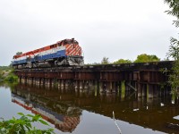 Ontario Southland has just finished Switching the PDI plant in the south end of Guelph. Still on their northbound run, they are heading south across the bridge to pick up their train so they can continue north into the city.