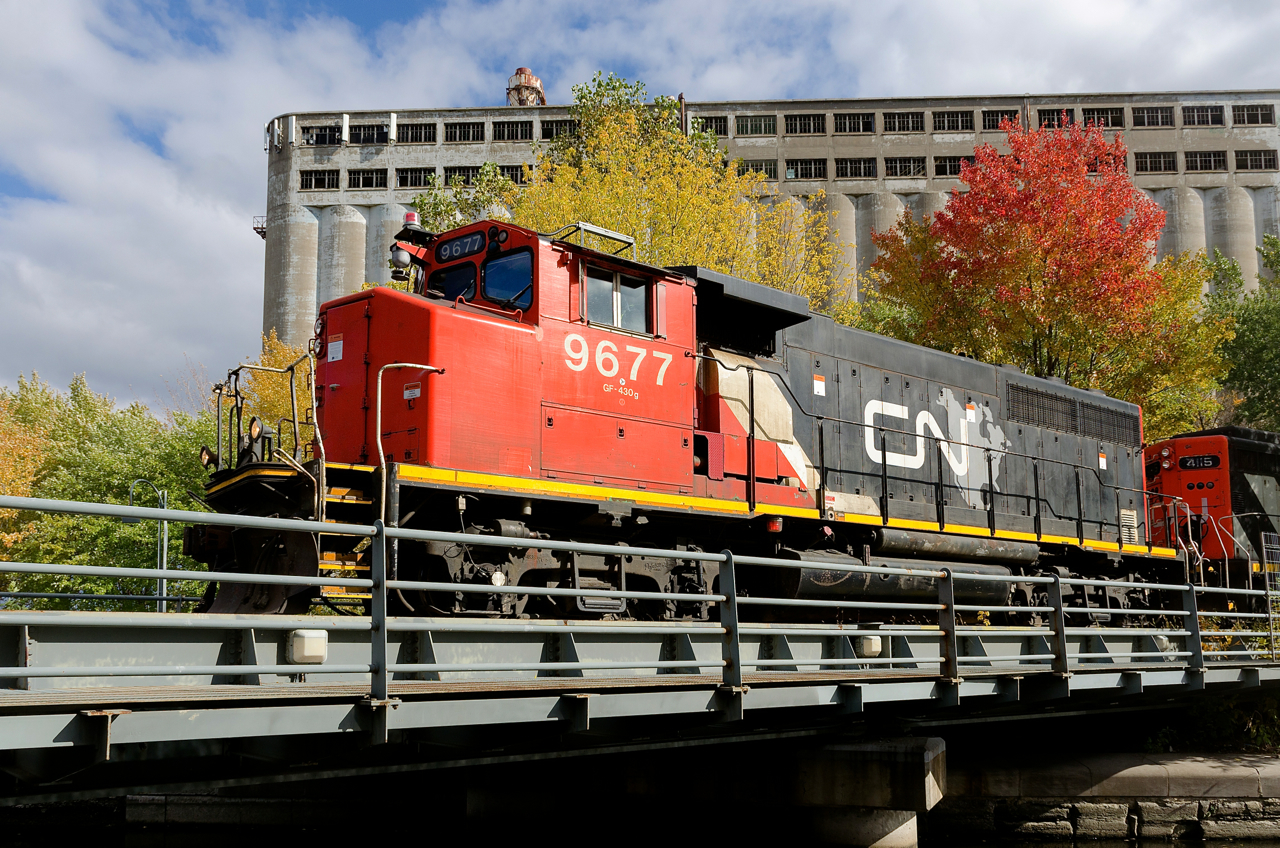 One of a handful of CN GP40's to be modified for beltpack (i.e. remote-control) use, CN 9677 leads the Pointe St-Charles switcher as it switches grain cars in front of the out of use grain elevator #5.