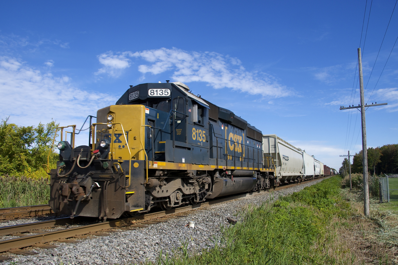 With only 49 cars on the drawbar (20 of which will be set off ahead at Coteau before continuing south), CSXT 8135 (an SD40-2 built as LN 8135 in 1981) is barely breaking a sweat as it approaches a crossing on CN's Kingston Sub.