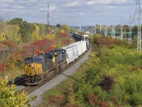 A short and fast CN 327 (224 axles and 59 MPH through the nearby detector at Caron) rounds a curve in Beaconsfield with CSXT 954 & CSXT 498 for power.