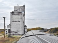<br>
<br> 
...grain elevators....vintage in service
<br>
<br> 
VIA Rail train #2 cruises through Punnichy, Saskatchewan
<br>
<br> 
the siding in front of the Elevator appears to have seen recent use, and Punnichy is shown as an active station on the CN Rail website
<br>
<br> 
September 20, 2018 digital by S.Danko
<br>
<br> 
what's interesting
<br>
<br>
place name  Punnichy is absent from the Watrous Subdivision Timetable, Punnichy is a couple miles East of Quinton mile 77.6 Watrous Subdivision
<br> 
<br>
note the Punnichy Cyclist admiring the train – bottom left corner
<br>
<br> 
another first for the photographer: two Park cars on the same The Canadian train (  I have seen this before, first time photo capture – better view to posted soon)
<br> 
<br> 
that 'green eye' was a pleasant sight as forward progress was frequently interrupted 
<br>
<br> 
vintage grain elevator: circa 1978 courtesy A.W.M.    
  <a href="http://www.railpictures.ca/?attachment_id=35072"> Broadview </a> 
     
<br>
<br> 
more vintage grain elevator: circa 1978 courtesy A.W.M.       
  <a href="http://www.railpictures.ca/?attachment_id=35014"> Coalhurst </a> 
<br>
<br> 
and contrast,  the Toronto section of the CP Rail The Canadian circa 1977 courtesy A.W.M.  
 <a href="http://www.railpictures.ca/?attachment_id=34614"> Parry Sound </a> 
 <br> 
<br> 
More (freshly painted) CP Rail:  
 <a href="http://www.railpictures.ca/?attachment_id=1644"> Kleinburg </a> 
<br> 
<br> 
sdfourty
