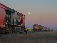 CN 758 and 863 are seen meeting at the east end of Biggar at dusk under a harvest moon.  