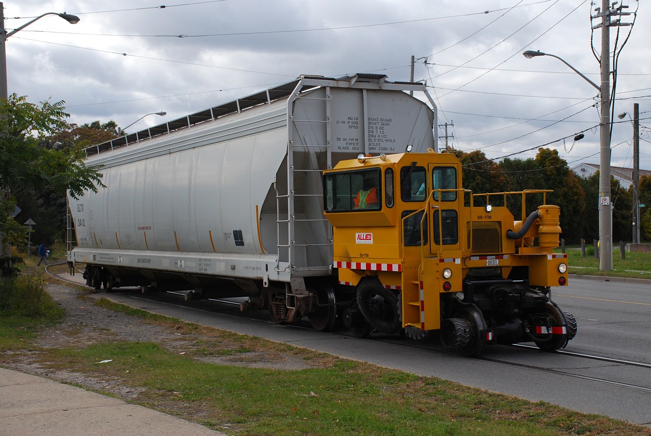 Learning how to run a railroad, one failure at a time.  The Mack truck hauling hoppers must have been deemed a failure because now a Track Mobile has arrived to operate Ingenia's spur.  I believe its first run was Monday, running light from Ingenia to the interchange, and returning with two hoppers uneventfully.  Today they attempted to haul three presumably empty hoppers back to CN but failed to do so.  They stalled at Greenwich Street with the three cars so left two behind and ran to the interchange with only one.  They then returned to retrieve the other two and stalled again...  blocking Greenwich Street for quite a while and royally messing up traffic at the adjacent intersection.  They tried again hauling just one hopper and again the Track Mobile stalled.  I don't know if it had a mechanical issue but you'd think it could handle a few empty hoppers.  Anyway after a few attempts they gave up and parked it.  Mack truck, Track Mobile... I wonder what they'll try next?