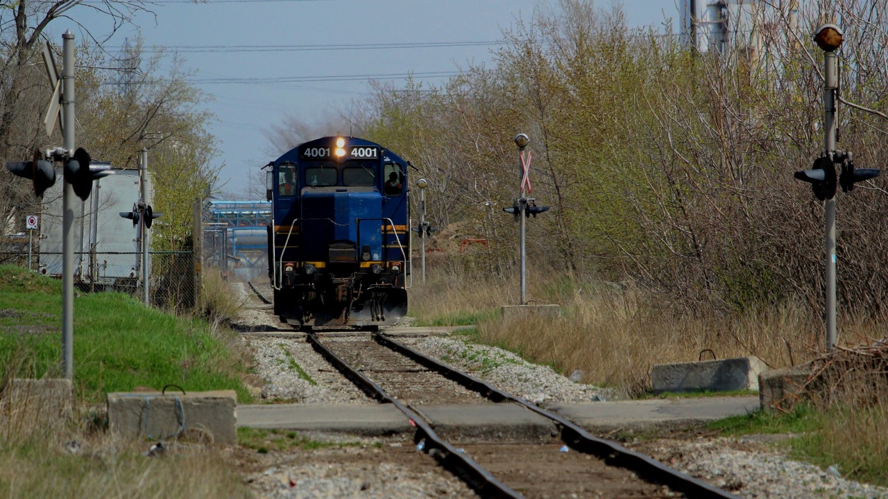I was heading back to Hamilton at the end of the day after a meeting in Burlington, and decided to pass by Stuart to see if anything was going on. Got there just in time to see the tail end of a cut of cols leaving the yard, headed towards the N&NW Spur. They dropped their cars west of Wentworth and ran light power eastward as pictured here. They returned not too long after with a string of tanks. I wondered at the time where those came from, but looking back at it I think a reasonable guess would be the interchange. I love this part of the N&NW Spur, where the crossings are packed in tight and mechanical bells still reign supreme.